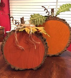 two pumpkins sitting on top of a wooden table