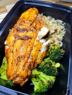 a plastic container filled with chicken, rice and broccoli