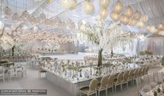 a large banquet hall with chandeliers hanging from the ceiling and tables covered in white linens