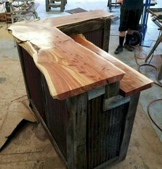 a man standing next to a wooden counter