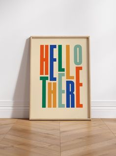 there is a poster that says hello there in multicolored letters on the wall