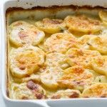 a casserole dish filled with potatoes and cheese