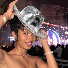 a woman wearing a silver hat at a concert