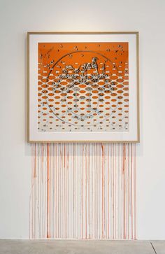 an orange and white painting hanging on the wall