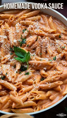 homemade vodka sauce in a pan with pasta and parmesan cheese