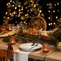 the table is set with candles and plates