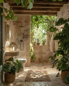 an outdoor bathroom with plants in the shower