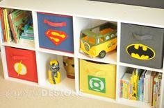 the toy bins are decorated with batman and superman decals on them for storage