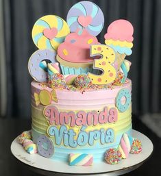 a birthday cake decorated with donuts, sprinkles and candy