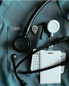 an assortment of medical supplies laid out on top of a blue sheet with black stethoscopes