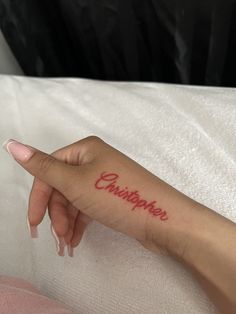 a woman's hand with a tattoo that says chinatown on the left side of her arm