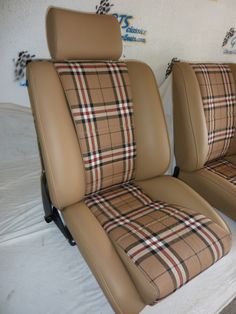 two tan leather seats with plaid seat covers