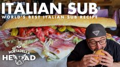 a man is eating a large sub sandwich