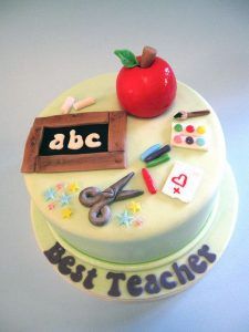 there is a cake that has an apple and scissors on it with the words best teachers