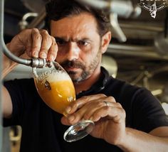 a man holding a beer glass in his hand