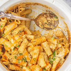 a white bowl filled with pasta and sauce