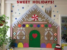 a gingerbread house made out of cardboard with candy and candies on the front