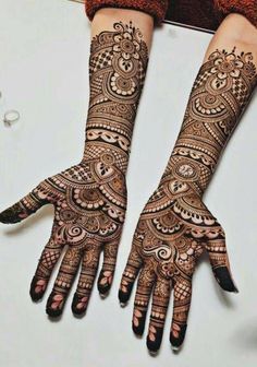 two hands with hendi designs on them