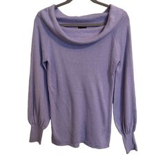 a purple sweater hanging on a hanger with it's hood pulled over the shoulder