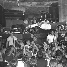 black and white photograph of band playing on stage