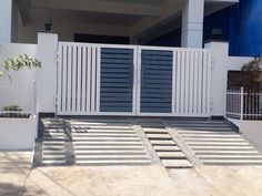 a white gate and steps leading to a house