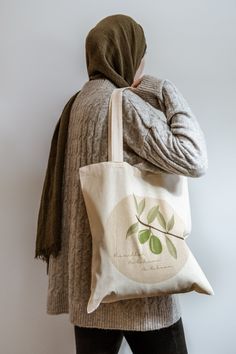 "This cute eco-conscious tote bag is made from 100% cotton fabric. It features our Olive Branch design with the inscription \"Bismillah Ar-Rahman Ar-Raheem\". Comes with a notice on how to wash it. - Dimension: 14x15 inches (without handles) - Great print quality - Capacity 10 litres - 100% cotton - Machine wash - Reinforced stitching on handles Copyright Niya Paper Art © All sizes are in inches" Organic Cotton Canvas Bag For Gift, Organic Cotton Bags Gift, Organic Cotton Bags For Gifts, Eco-friendly Handmade Beige Canvas Bag, Organic Cotton Bags For Gift, Organic Cotton Bag For Gift, Eco-friendly Embroidered Cotton Bags, Eco-friendly Embroidered Everyday Bag, Boho Style House