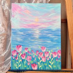 an acrylic painting of pink tulips in front of the ocean at sunset