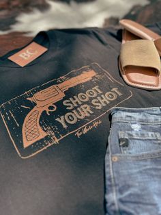 Step out in style with Big Country's Western Wear's Shoot Your Shot Tee. Crafted for comfort and designed with a traditional western touch, this tee is perfect for those who value both fashion and quality. Featuring a bold graphic and made with premium materials, it's the ideal choice whether you're at the ranch or in town. Shop now and add a classic piece to your wardrobe! Big Country, Western Design, Country Western, The Ranch, Western Wear, Shop Now, Wardrobe, How To Wear, Design