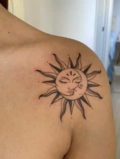 a woman with a sun tattoo on her shoulder