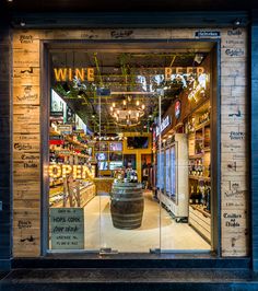 a store front with an open wine barrel in the window