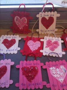 valentine's day crafts made out of popsicle sticks and paper hearts on display