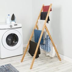 a washer and dryer in a room next to a laundry basket with clothes on it