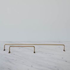 a white marble counter top with two brass handles