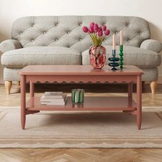 a pink coffee table sitting in front of a couch