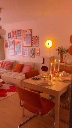 a living room filled with lots of furniture next to a dining table and two couches