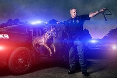 a police officer standing next to his patrol dog