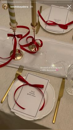 the place setting is decorated with red ribbon