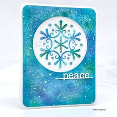 a blue and white card with a snowflake design on the front that says peace