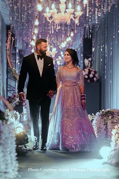 a man and woman walking down a runway