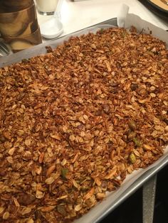 a pan filled with granola sitting on top of a counter