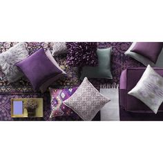 a purple couch with several pillows on it