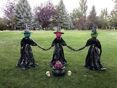 three witches holding hands in the grass