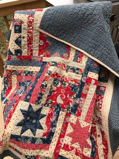 an old quilt is laying on top of a chair