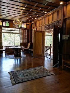 an empty room with wooden paneling and chandelier