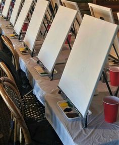 there are many easels lined up on the table