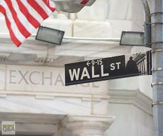 a street sign on the corner of wall st and stock exchange