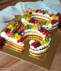 a cake shaped like the number 50 with fruit toppings