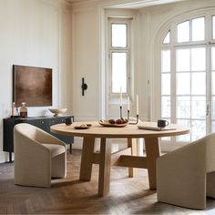 a dining room table with two chairs around it