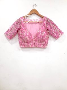 This Made to Order/Made to Measurement/Custom Made Indian Ethnic Blouse. - Fabric - Embroidered Net - Color  pink - Princess Cut - Rich Lined - Shoulder string with latkans - Sleeveless - Extra margin and extra stitches included in the blouse - It can be customize in any color, design or size  MEAUREMENTS & CUSTOMIZATIONS This blouse can be purchased in your standard sizing and pattern. Please choose your Chest Size (measured in inches) from the drop-down box.. For custom sizing please include the below measurements in the the notes to whenever you placed the order. * Chest size: * Waist size: * Blouse Length: * Bicep: * Arm-hole: * Sleeve Length: * Front Neck Depth: * Back-Neck Depth:  Sleaves Around PLEASE NOTE: BUYERS ARE RESPONSIBLE FOR ANY CUSTOMS AND IMPORT TAXES THAT MAY APPLY. This V-neck Traditional Wear With Resham Embroidery For Party, Party V-neck Traditional Wear With Zari Work, Festive V-neck Choli For Reception, Festive Party Wear Choli With Floral Embroidery, Traditional V-neck Party Sets, Festive Floral Embroidered Party Wear Choli, Festive Floral Embroidered Party Choli, Festive Fitted Lehenga With Floral Embroidery, Fitted Floral Embroidered Lehenga For Festive Season