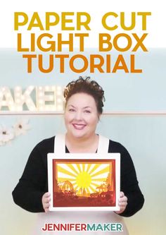 a woman holding up a paper cut light box in front of her face with the words,